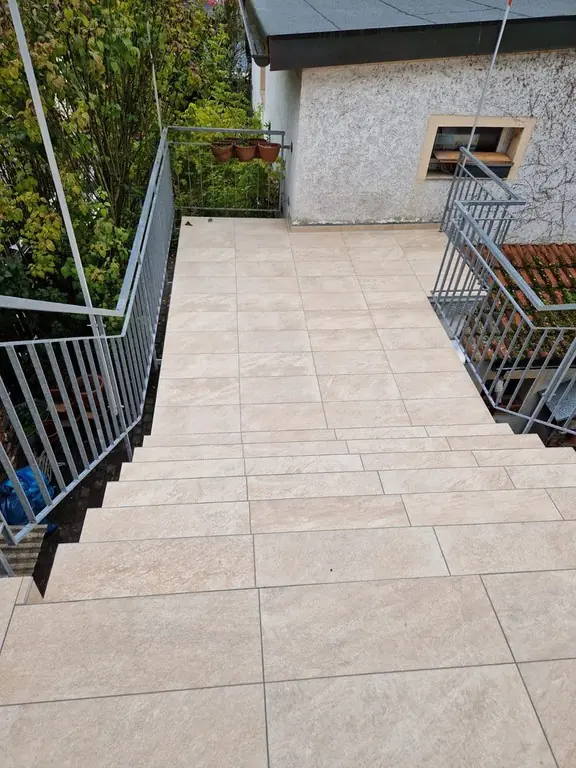 Terrasse mit hellen Feinsteinzeugplatten und neuem Geländer – Fliesen Berisha Neulußheim